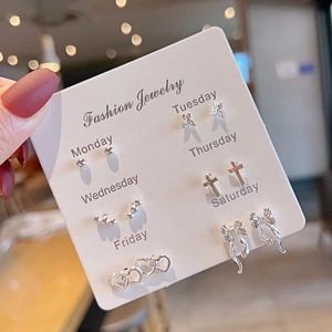 Detailed view of six pairs of silver-toned studs including hearts and butterfly bows