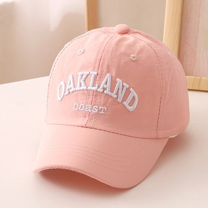 Close-up of pink quick-dry baseball cap with white OAKLAND coast embroidery and curved brim