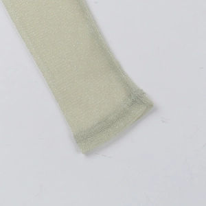 Detailed macro view of champagne mesh sleeve cuff with subtle metallic shimmer fabric