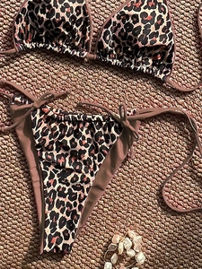 Detailed flat lay of leopard print bikini set with triangle cups and side-tie bottoms