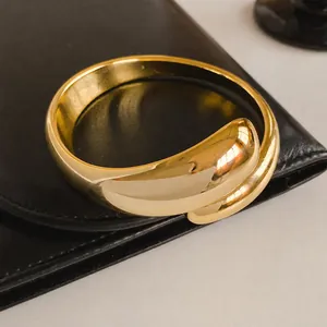 Luxury gold-plated fluid wave open bangle with polished mirror finish for women