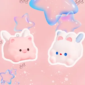 Cute resin flying pig and bunny keychain charms with wings on soft pink background
