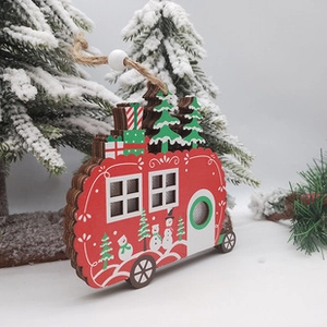 Detail of a red wooden camper ornament with a Christmas tree and snowman on top