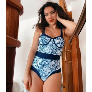 Detail of blue and white floral print swimsuit with belt and gathered cups