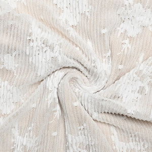 Gros plan sur la dentelle blanche délicate et la texture en tricot ajouré de la robe