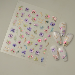 Detail of 3D embossed floral nail stickers with gold accents and lettering art