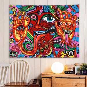 Detail of psychedelic wall tapestry featuring surreal eye and pop art pattern in a room
