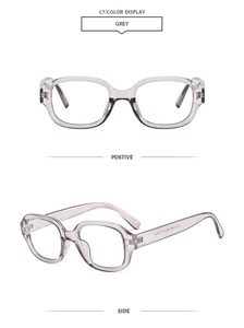 Front and side view of grey translucent oval sunglasses frame with metal rivet details