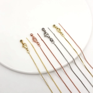 Detailed view of adjustable 14k gold-plated necklaces in gold, rose gold and silver finishes
