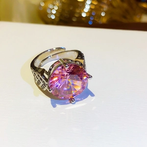Close-up of pink oval zircon ring with classic four-prong silver-toned setting