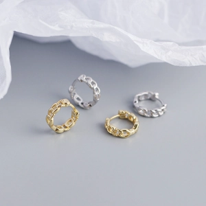 Detail view of gold and silver chain link hoop earrings with 925 sterling silver engraving