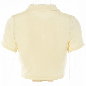Rear view of light yellow short-sleeved polo shirt showing soft texture and cropped hem