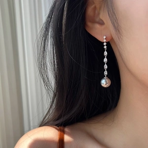 Elegant long drop earrings with cubic zirconia crystals and a greyish-white pearl pendant