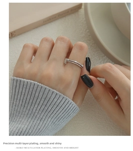 Detail of s925 silver double layer zircon ring worn by a model in a minimalist style