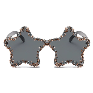 Star-shaped sunglasses with dark grey lenses and hand-set sparkling orange crystals