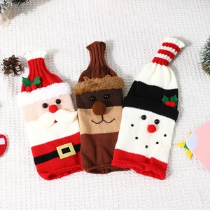 Knitted Christmas wine bottle covers featuring Santa, reindeer, and snowman designs