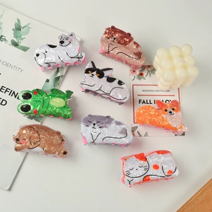 Cute animal acetate hair claws with cat and dog designs for a stylish bun hairstyle