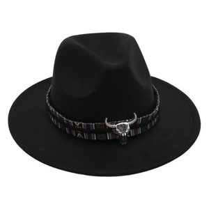 Close-up of black felt fedora hat featuring ethnic ribbon and silver bull head ornament