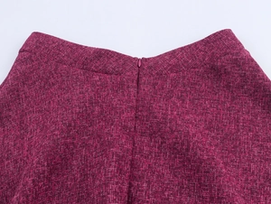 Close-up of the back waist detail with hidden zipper on a burgundy tweed skirt
