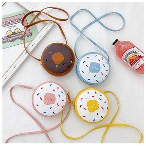 Flat lay of colorful donut-shaped mini crossbody bags for girls in various colors