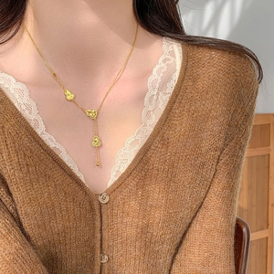 Detail of 18k gold plated gourd pendant necklace worn on model for elegant look