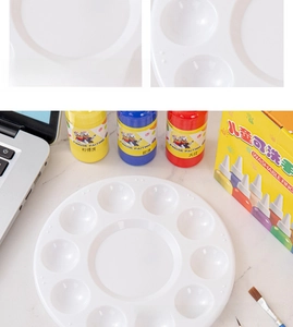 Macro detail of a white plastic paint palette with multiple wells and washable kid's paints