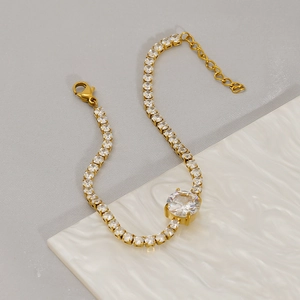 Elegant gold tennis bracelet with central round zircon and adjustable lobster clasp