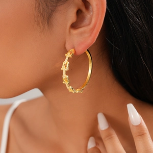 Close-up of 18K gold plated U-shaped chain hoop earrings with cubic zirconia on model