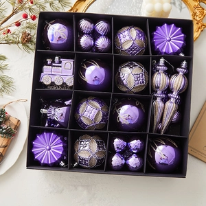 Purple Christmas ornament set with glitter balls and train shapes in a gift box