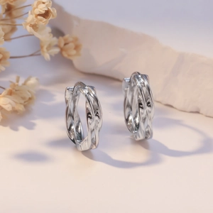 Polished silver woven twist hoop earrings with 925 silver needle for a stylish look