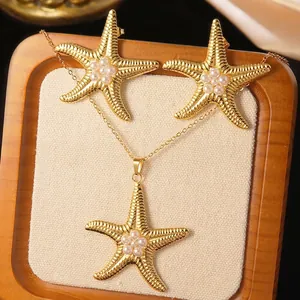 Detailed view of starfish jewelry set with white pearls in a wooden display tray