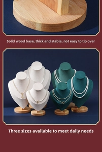Detail of wooden base jewelry displays for necklaces in green and white velvet fabric