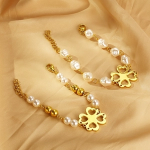 Elegant gold titanium clover bracelets with pearls and hollow heart charms on satin