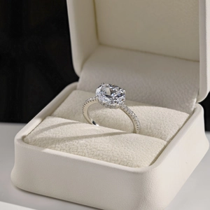 Close-up of S925 sterling silver ring with large round zircon in a cream jewelry box