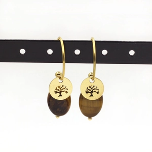 Detail of tree of life charm and tiger eye stone beads on golden steel earrings