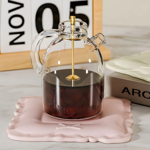 Bowknot silicone coaster mold used for a glass coffee pot with pink heat-resistant base