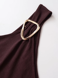 Detail of burgundy knit dress with a decorative golden triangle metal buckle