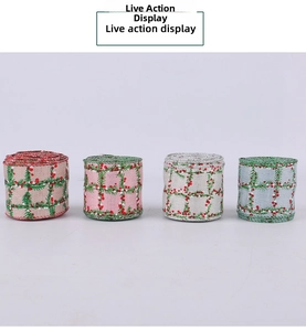 Close-up of four rolls of Christmas plaid ribbons with pine needle and berry patterns