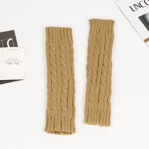Close-up of camel knit arm warmers with classic cable stitch texture on white background
