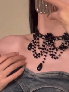 Gothic beaded choker necklace with black teardrop pendants worn by a model