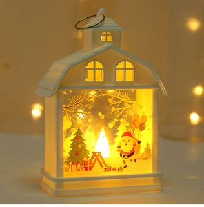 Close-up of white Christmas house lantern with Santa Claus motif and warm LED light