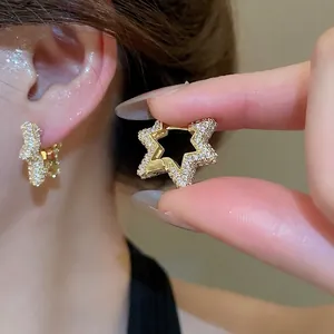 Elegant gold star huggie hoop earrings with white zircon stones for a luxury fashion look