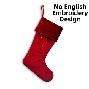 Detail of red velvet Christmas stocking with golden stars and a hanging loop