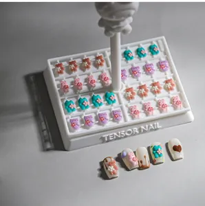 Detailed view of colorful 3D resin bear and rabbit nail art charms on a white display card