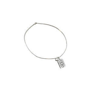 Silver necklace with zircon round stone and intricate hollow square pendant on white background