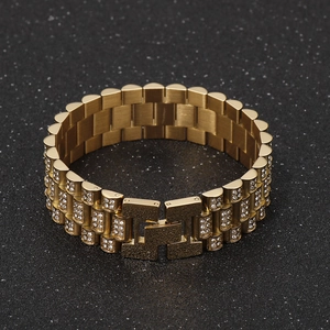 Close-up of gold-plated hip hop bracelet with iced-out zircon pave and H-link buckle