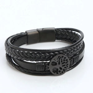 Close-up of black braided leather bracelet featuring a stainless steel Tree of Life charm