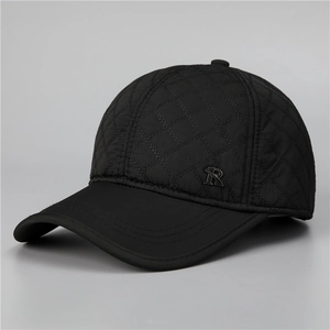 Close-up of black quilted diamond pattern and metal R detail on a winter baseball cap