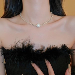 Detail of a minimalist pearl pendant necklace with silver geometric link chain for women
