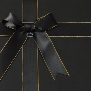 Black folding gift box with premium gold-edged satin ribbon bow detail and matte finish